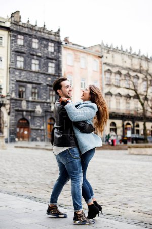 Photo for Stylish happy couple enjoying a date on the street of a European city - Royalty Free Image