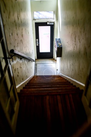 Photo for Stairwell in an old building looking down towards  entrance - Royalty Free Image