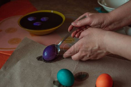 Foto de Woman paints Easter eggs for spring holiday - Imagen libre de derechos