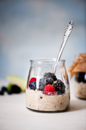 Photo for Healthy morning oatmeal and berries in glass bowl - Royalty Free Image