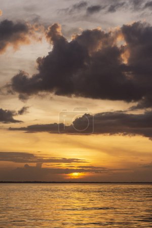 Foto de Beautiful view to orange sunset clouds and river in the Amazon Rainforest, near Manaus, Amazonas State, Brazil - Imagen libre de derechos