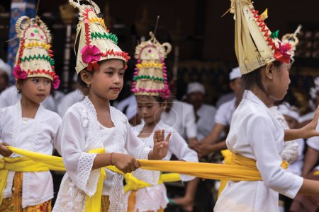 Photo for Young Balinese girls dancing during Kuningan ceremony in Bali - Royalty Free Image