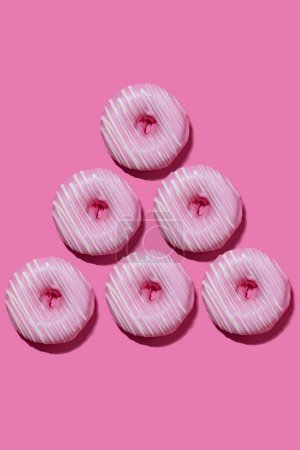Photo for Raspberry donuts in pink glaze on a pink background. pattern. - Royalty Free Image