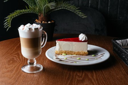 Photo for Cheesecake and coffee on a wooden table in a coffee shop - Royalty Free Image