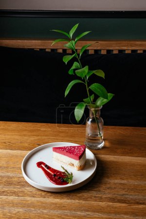 Photo for Cheesecake and coffee on a wooden table in a coffee shop - Royalty Free Image