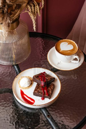 Photo for Cappuccino and chocolate brownie with ice cream on a glass table - Royalty Free Image