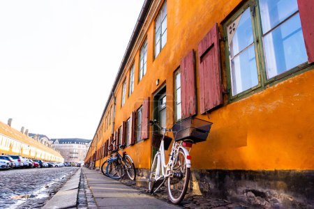 Photo for Bikes stuck on the walls of the Nyboder neighborhood of Copenhagen - Royalty Free Image