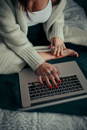 Photo for Tattoed woman typing on her laptop closeup - Royalty Free Image
