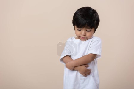 Téléchargez les photos : Scolded or sad little Mexican boy, sad expression - en image libre de droit