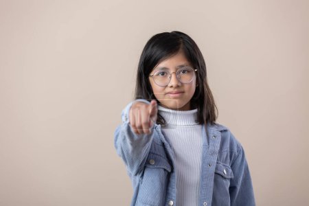 Photo for Portrait of a Mexican young girl pointing at camera - Royalty Free Image