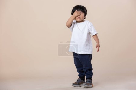 Photo for Mexican three year old boy covering his eyes - Royalty Free Image