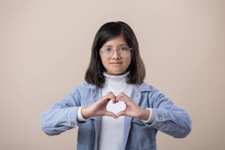 Photo for Mexican young girl making heart with hands, self love, women's rights - Royalty Free Image