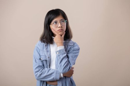 Photo for Mexican young woman wearing glasses, thinking expression - Royalty Free Image
