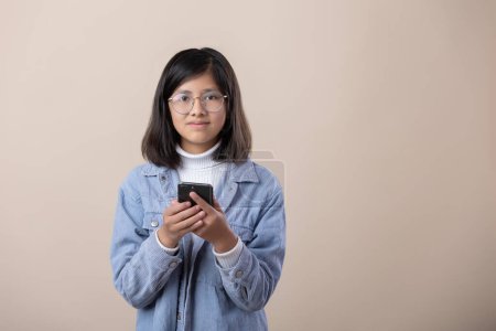 Photo for Portrait of Mexican girl with smart phone and glasses - Royalty Free Image