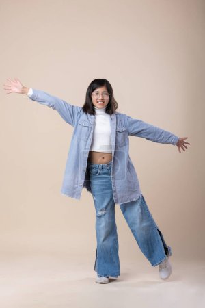 Photo for Mexican girl happiness jump, blue jeans - Royalty Free Image