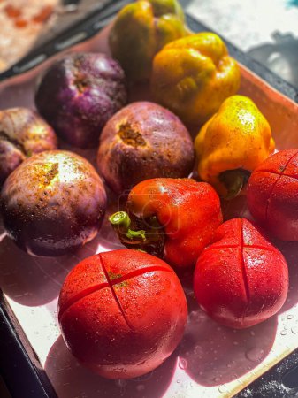 Photo for Tomatoes and yellow peppers on a baking sheet - Royalty Free Image