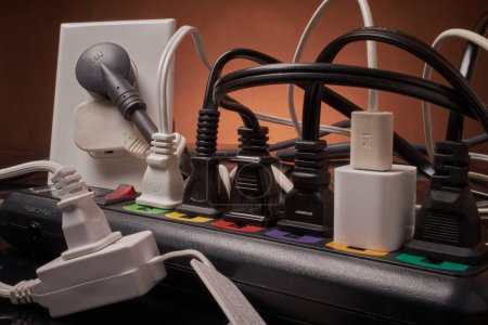 Photo for Electrical outlets and power strip overloaded beyond capacity - Royalty Free Image