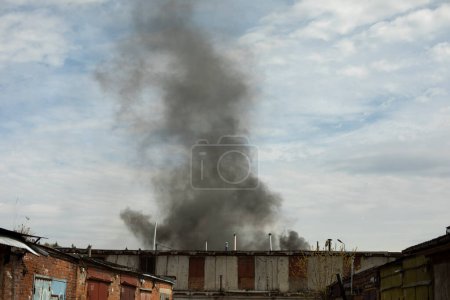 Photo for Burning of building. Smoke over buildings. Smoke in sky. - Royalty Free Image