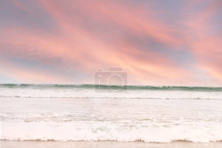 Pink sunset over the ocean waves