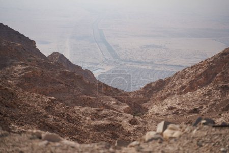 Photo for Desert mountain landscape overlooking the city through the gorge. - Royalty Free Image