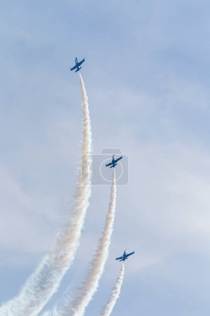 Téléchargez les photos : Breitling jets formation at Aerolac with smoke trail - en image libre de droit