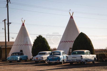 Photo for Rusty Classic Cars Parked in front of Teepees at the Wigwam Motel - Royalty Free Image