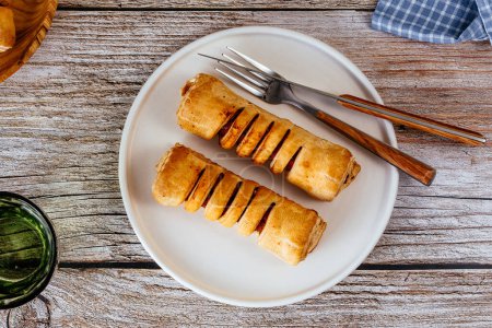 Téléchargez les photos : Homemade sausage in dough in a plate - en image libre de droit
