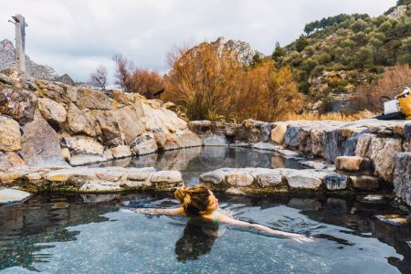 Photo for Portrait of woman in natural hot springs swimming - Royalty Free Image