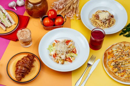 Foto de Italian pasta, pizza and caesar salad on bright backgrounds. mockup for text insertion - Imagen libre de derechos