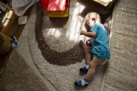Photo for Child asleep on floor near the mattress - Royalty Free Image
