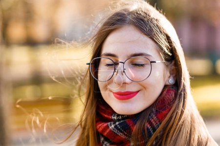 Photo for Young woman in glasses wrapped in a scarf - Royalty Free Image