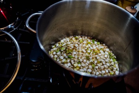 Photo for View from Above of Large Soup Pot Warming Onions, Celery and Broth - Royalty Free Image