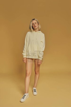 Photo for Young freckles woman wearing a yellow sweatshirt - Royalty Free Image
