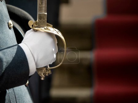 Photo for A soldier in military parade uniform holds a cavalry or naval sword - Royalty Free Image