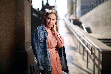 Foto de Hermosa joven con vestido y posando en la calle de la ciudad - Imagen libre de derechos
