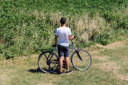 Photo for Attractive young male riding bicycle in the Island of Batz - Royalty Free Image