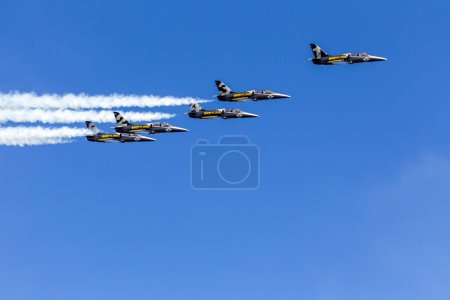 Photo for Breitling jet team formation at Aerolac with smoke trail - Royalty Free Image