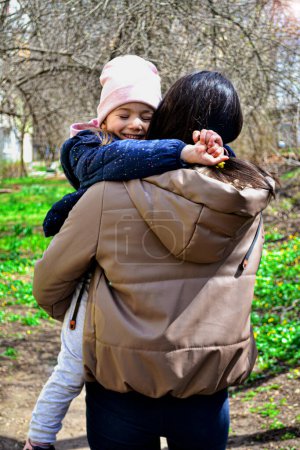 Photo for Mum carring doughter while she hugs her neck - Royalty Free Image