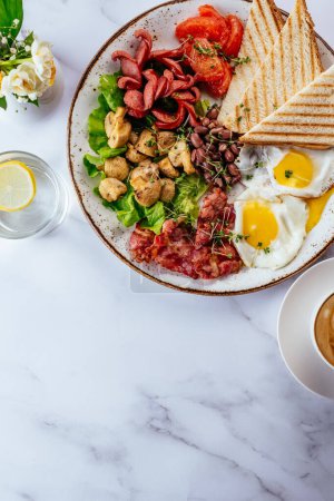 Photo for English breakfast with scrambled eggs, bacon, beans, mushrooms and coffee on a marble table - Royalty Free Image