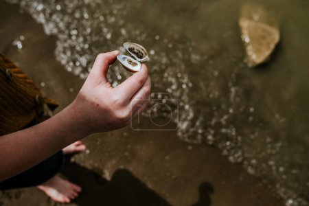 Photo for Child holding shell on lakeshore - Royalty Free Image