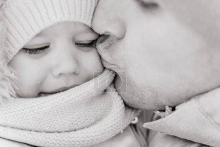 Photo for Close-up B&W portrait of a ruddy baby toddler and dad on a cold winter - Royalty Free Image