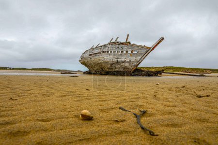 Photo for Boat shipwrecked on beach in Ireland - Royalty Free Image