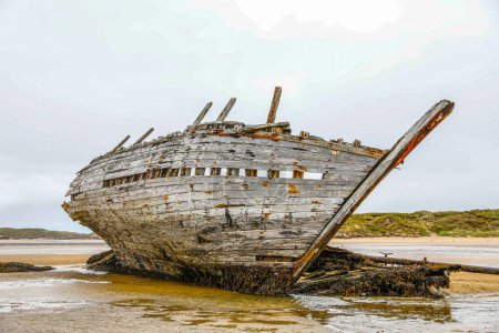 Photo for Abandoned boat along shore in Ireland - Royalty Free Image
