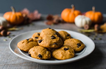 Photo for Close up of plate of pumpkin chocolate chip cookies on wooden table. - Royalty Free Image