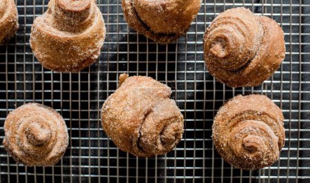 Photo for Homemade cinnamon buns on a cooling rack - Royalty Free Image