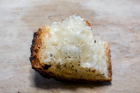 Photo for Close-up of a chunk of airy artisanal bread with caramelized crust - Royalty Free Image