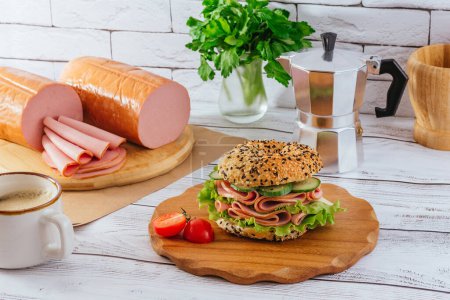 Photo for Bagel with ham and herbs. ham is nearby. coffee. breakfast. - Royalty Free Image