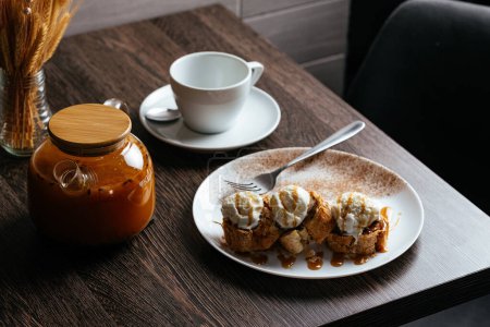 Photo for Apple pie with ice cream balls, tea in a teapot - Royalty Free Image