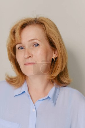 Photo for Attractive gorgeous mature older woman looking at camera isolated on white background advertising skincare spa treatment. Mid age tightening face skin care rejuvenation cosmetics concept. Portrait - Royalty Free Image