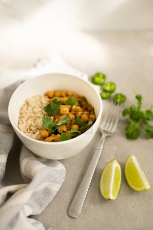 Photo for Chickpea Curry with Rice, Cilantro Garnish, Lime and Jalapeo Slices - Royalty Free Image